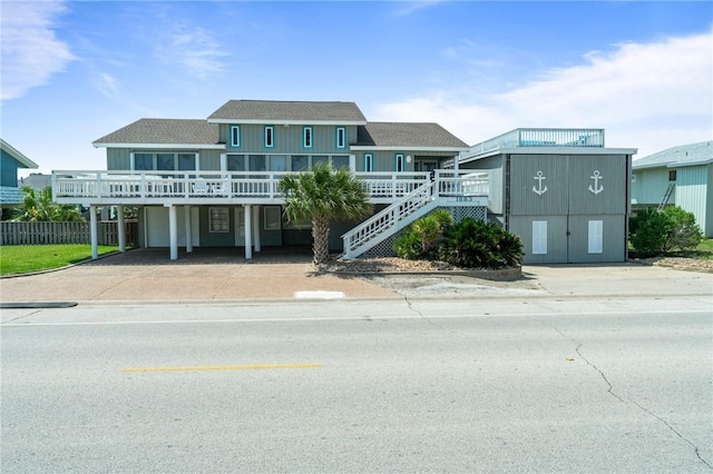 view of building exterior featuring stairway and driveway