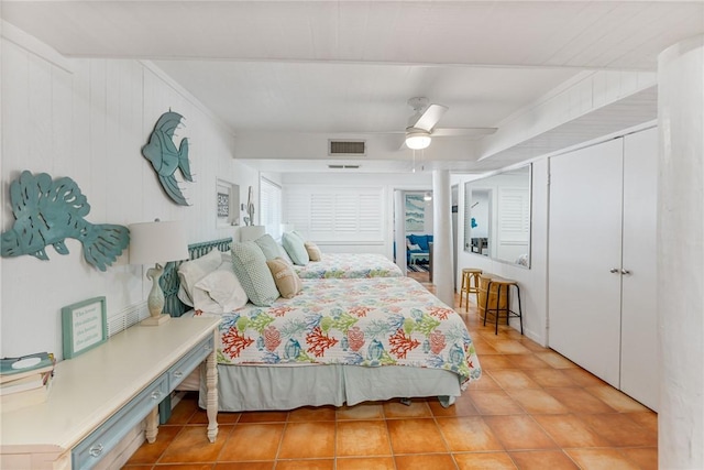 tiled bedroom featuring a ceiling fan and visible vents