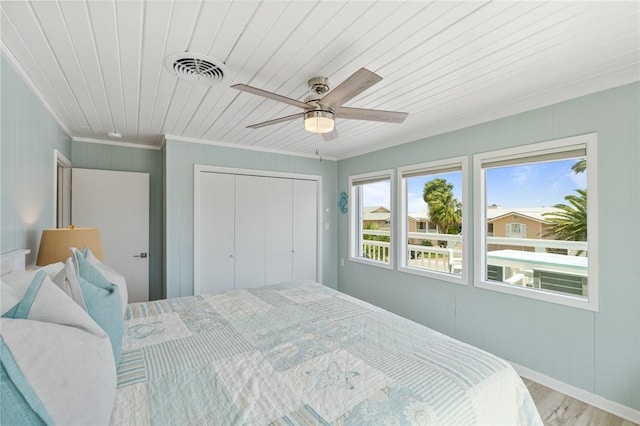 bedroom with visible vents, a closet, wooden ceiling, ceiling fan, and wood finished floors