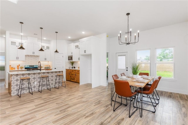 2513 Luzius Dr, Corpus Christi, TX 78418 - dining area with a chandelier, light wood-style floors, recessed lighting, and baseboards
