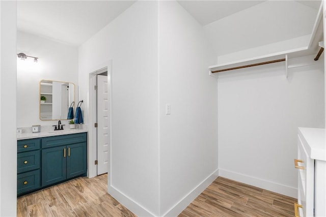 2513 Luzius Dr, Corpus Christi, TX 78418 - bathroom with vanity, wood finished floors, and baseboards
