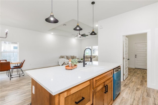 2513 Luzius Dr, Corpus Christi, TX 78418 - kitchen with stainless steel dishwasher, a sink, light wood-style flooring, and decorative light fixtures