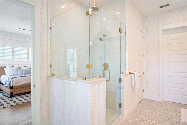 bathroom with wood-type flooring and a shower with door