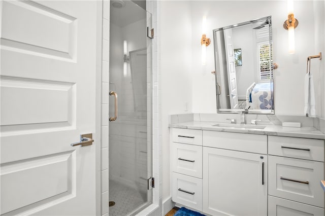 bathroom featuring walk in shower and vanity