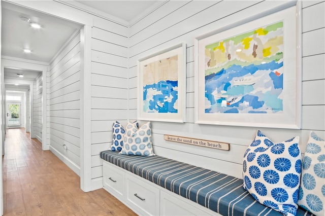 mudroom featuring wooden walls and light hardwood / wood-style flooring