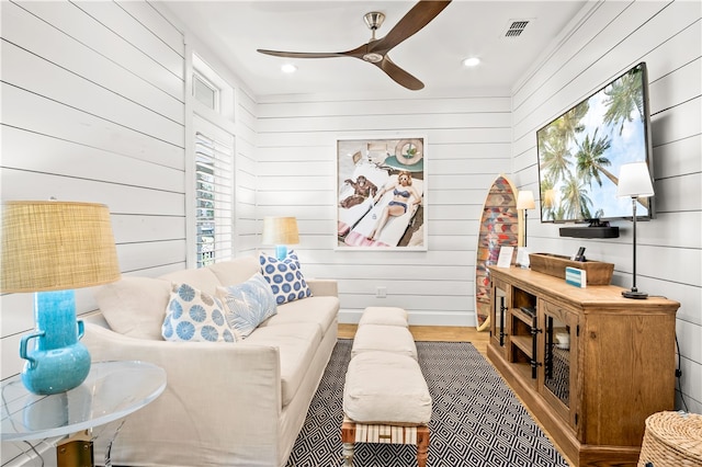 living room with wood walls and light wood-type flooring