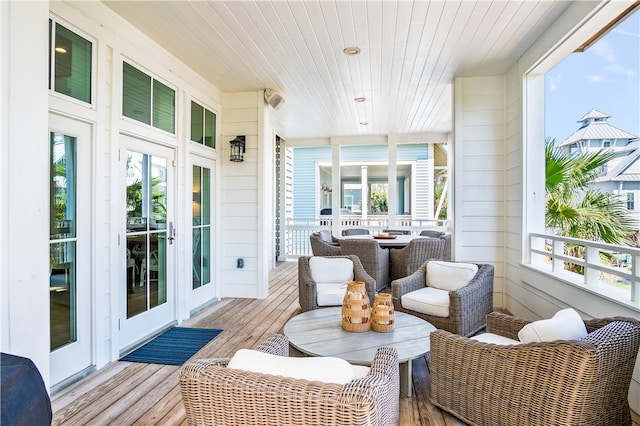 sunroom / solarium with a healthy amount of sunlight and wooden ceiling