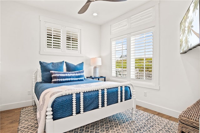 bedroom with ceiling fan and wood-type flooring