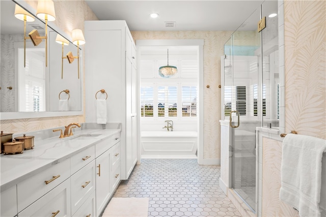 bathroom featuring vanity, shower with separate bathtub, and tile patterned flooring