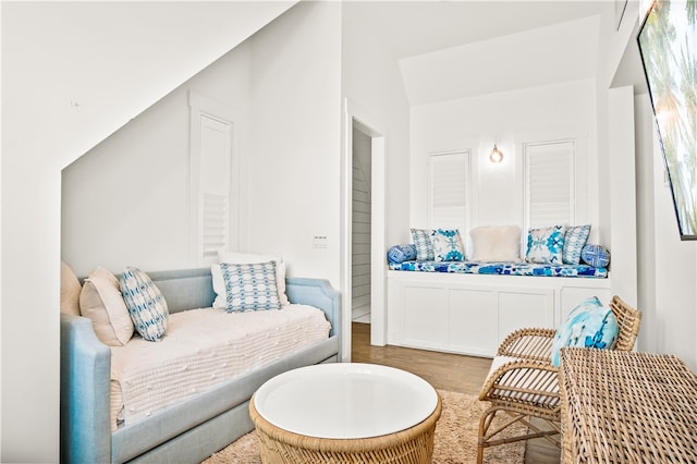 living area with lofted ceiling and hardwood / wood-style floors