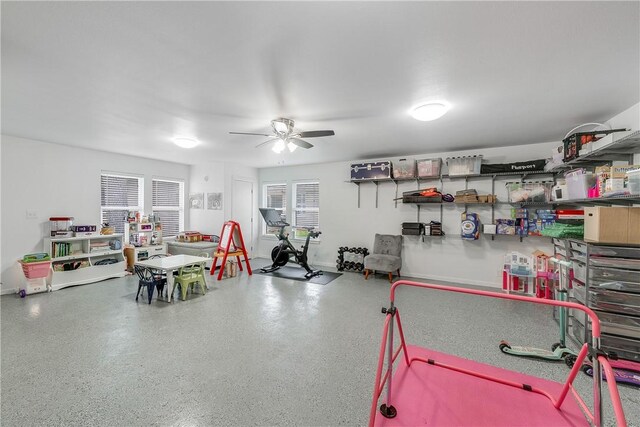 rec room featuring a ceiling fan and speckle patterned floor