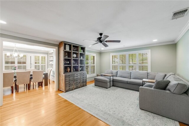 living room with light wood-type flooring, a chandelier, recessed lighting, healthy amount of natural light, and ceiling fan