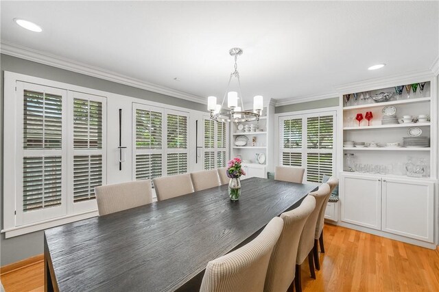 dining room featuring a chandelier, ornamental molding, light wood finished floors, and recessed lighting
