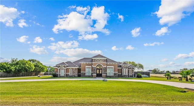 221 Deer Meadows Dr, Alice, TX 78332 - view of front of property featuring stone siding, curved driveway, and stucco siding