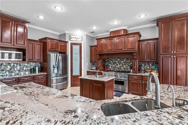 221 Deer Meadows Dr, Alice, TX 78332 - kitchen featuring appliances with stainless steel finishes, a sink, recessed lighting, tasteful backsplash, and light stone counters