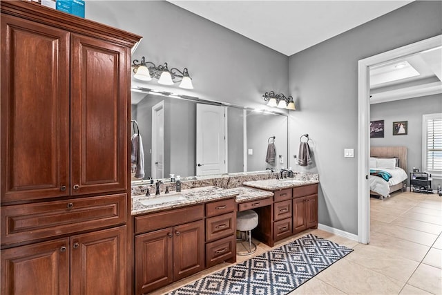 221 Deer Meadows Dr, Alice, TX 78332 - bathroom featuring double vanity, tile patterned flooring, connected bathroom, and baseboards