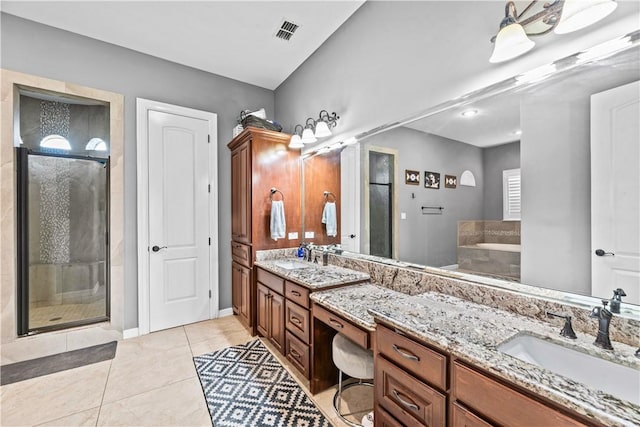 221 Deer Meadows Dr, Alice, TX 78332 - full bathroom featuring double vanity, a stall shower, tile patterned floors, a bath, and baseboards