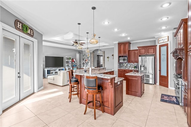 221 Deer Meadows Dr, Alice, TX 78332 - kitchen with appliances with stainless steel finishes, a large island with sink, ornamental molding, tasteful backsplash, and recessed lighting
