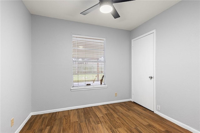 unfurnished room featuring dark hardwood / wood-style floors and ceiling fan