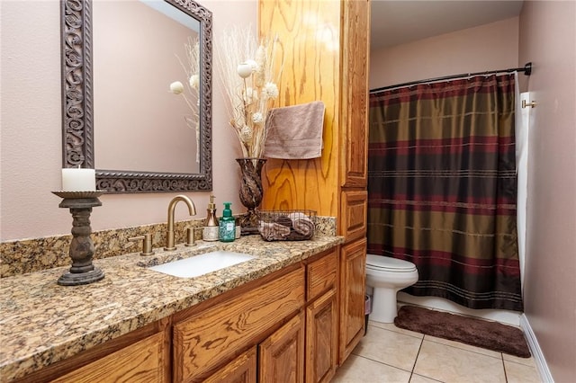 bathroom featuring vanity, tile patterned flooring, and toilet