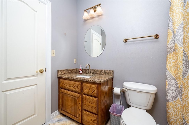 bathroom featuring vanity and toilet