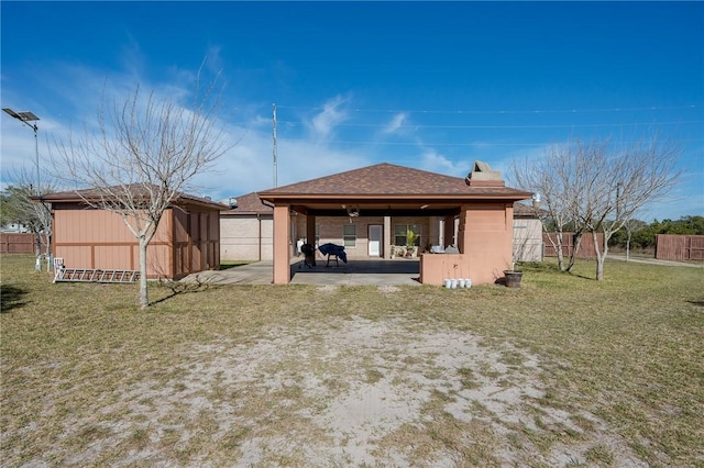 back of house featuring a yard