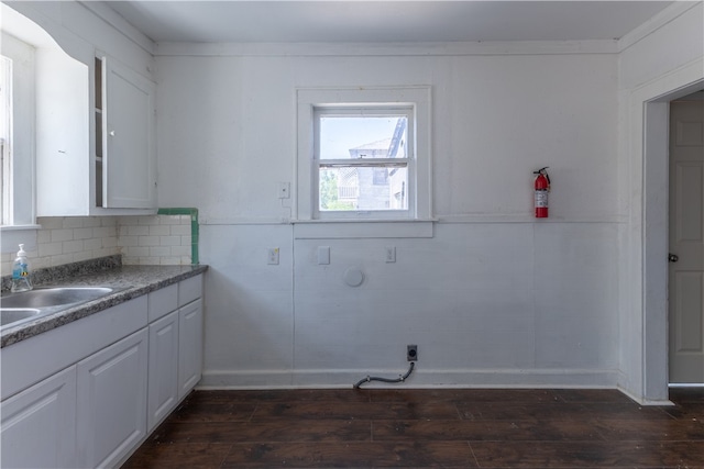 kitchen featuring white cabinets, dark hardwood / wood-style floors, sink, and ornamental molding