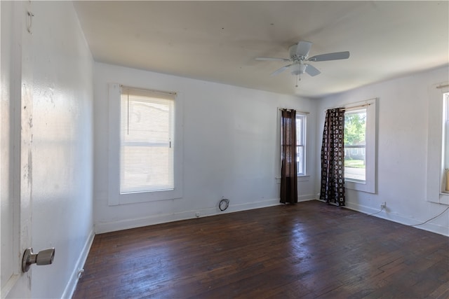 spare room featuring dark wood-type flooring and ceiling fan