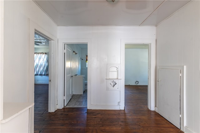 corridor with dark hardwood / wood-style flooring