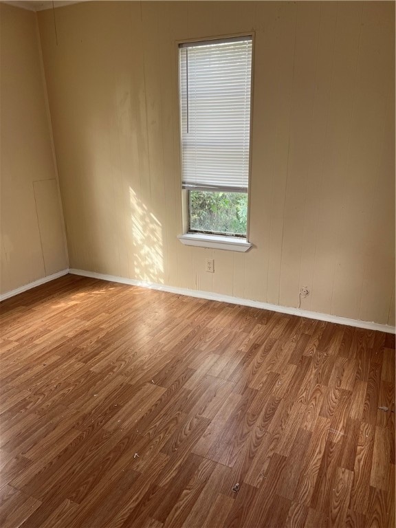 unfurnished room with wood-type flooring