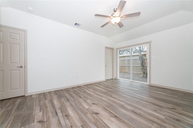 unfurnished room with ceiling fan, lofted ceiling, and light wood-type flooring