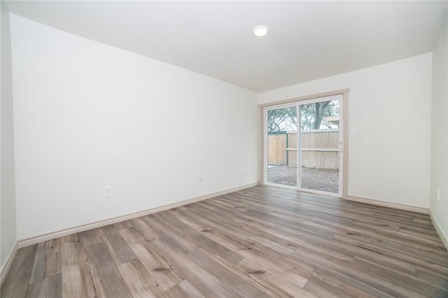 spare room with hardwood / wood-style flooring