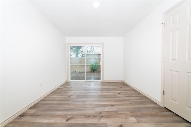 unfurnished room with light wood-type flooring