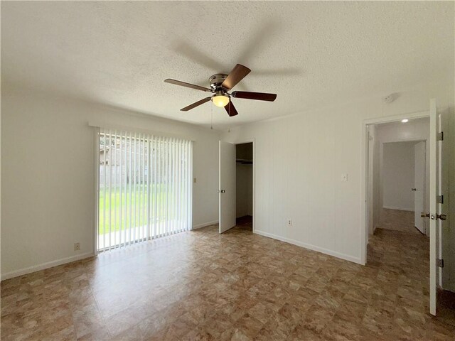 unfurnished bedroom featuring ceiling fan, a closet, baseboards, and a textured ceiling