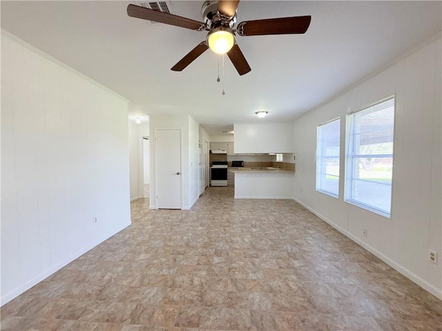 unfurnished living room with ceiling fan and baseboards