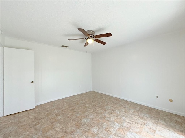 spare room with baseboards, visible vents, a ceiling fan, a textured ceiling, and light floors