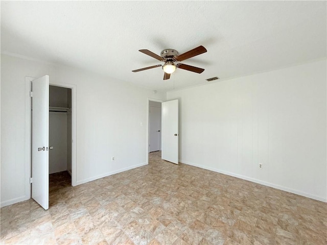 unfurnished bedroom featuring a ceiling fan, a closet, visible vents, and baseboards