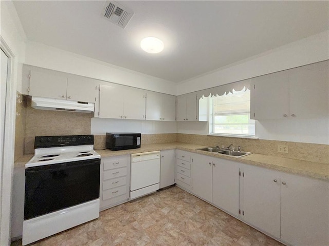 kitchen featuring white appliances, visible vents, light countertops, under cabinet range hood, and a sink