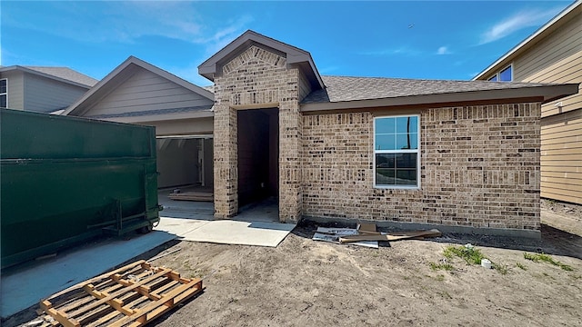 10321 Stone Creek Dr, Corpus Christi, TX 78410 - property entrance featuring a shingled roof and brick siding