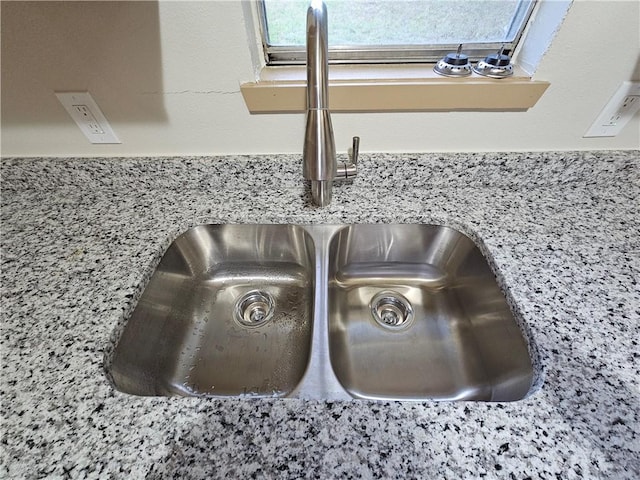 details with light stone countertops and sink