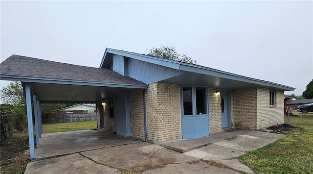 view of home's exterior featuring a carport and a lawn