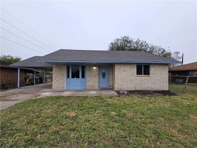 ranch-style house featuring a carport and a front lawn