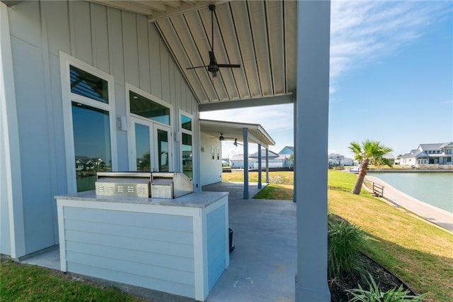 view of patio / terrace featuring a water view and ceiling fan