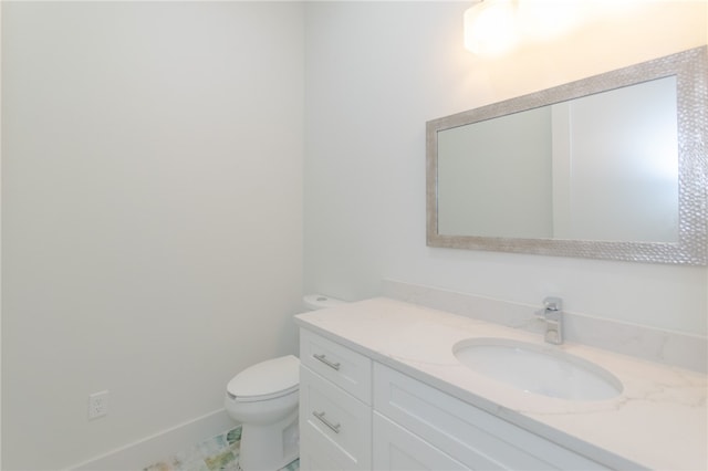 bathroom featuring toilet and vanity