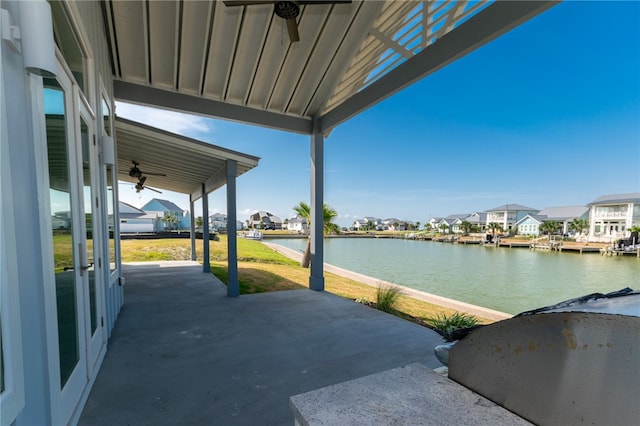 view of patio featuring a water view and ceiling fan