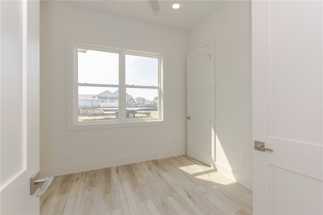 unfurnished room featuring light wood-type flooring and a wealth of natural light