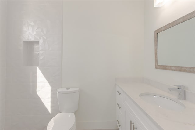 bathroom featuring toilet and vanity