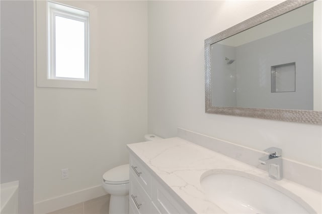 bathroom with tile patterned flooring, vanity, and toilet