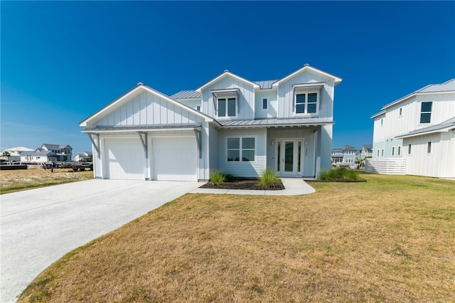 view of front of house featuring a front lawn and a garage