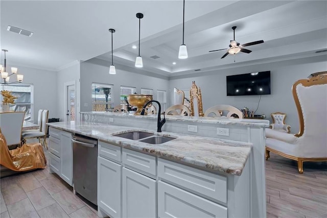 kitchen with white cabinets, sink, an island with sink, stainless steel dishwasher, and light wood-type flooring